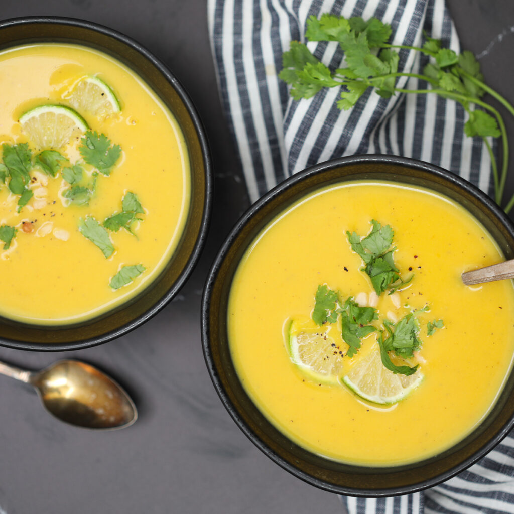 recipe for vegan butternut squash soup ready to eat in  black bowls